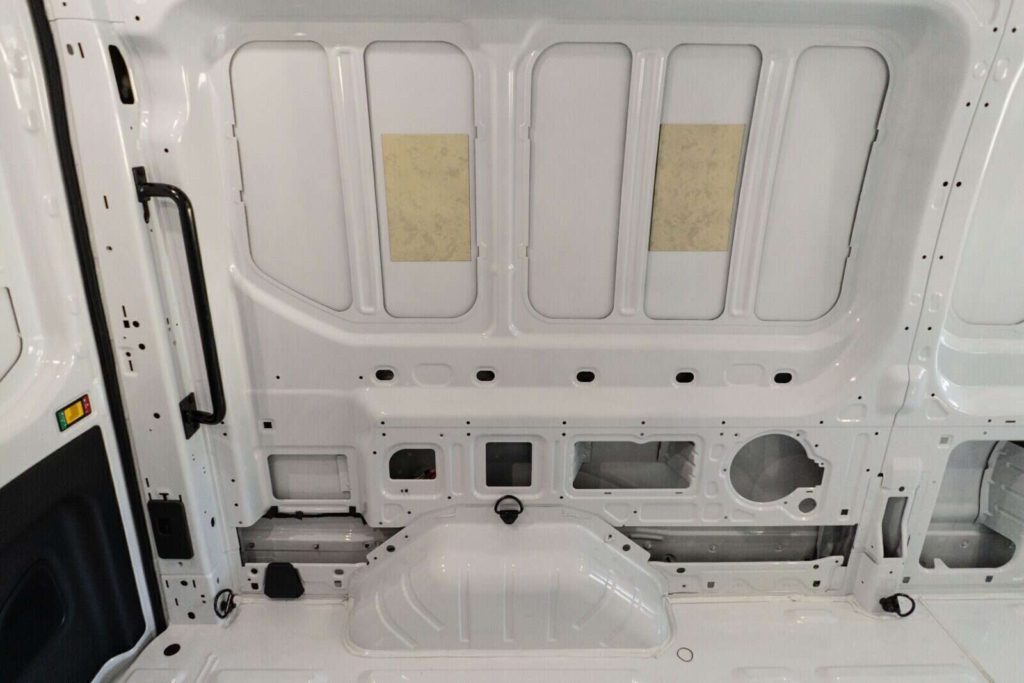 Interior of Ford Transit cargo van sheet metal on driver's side, before camper van conversion.