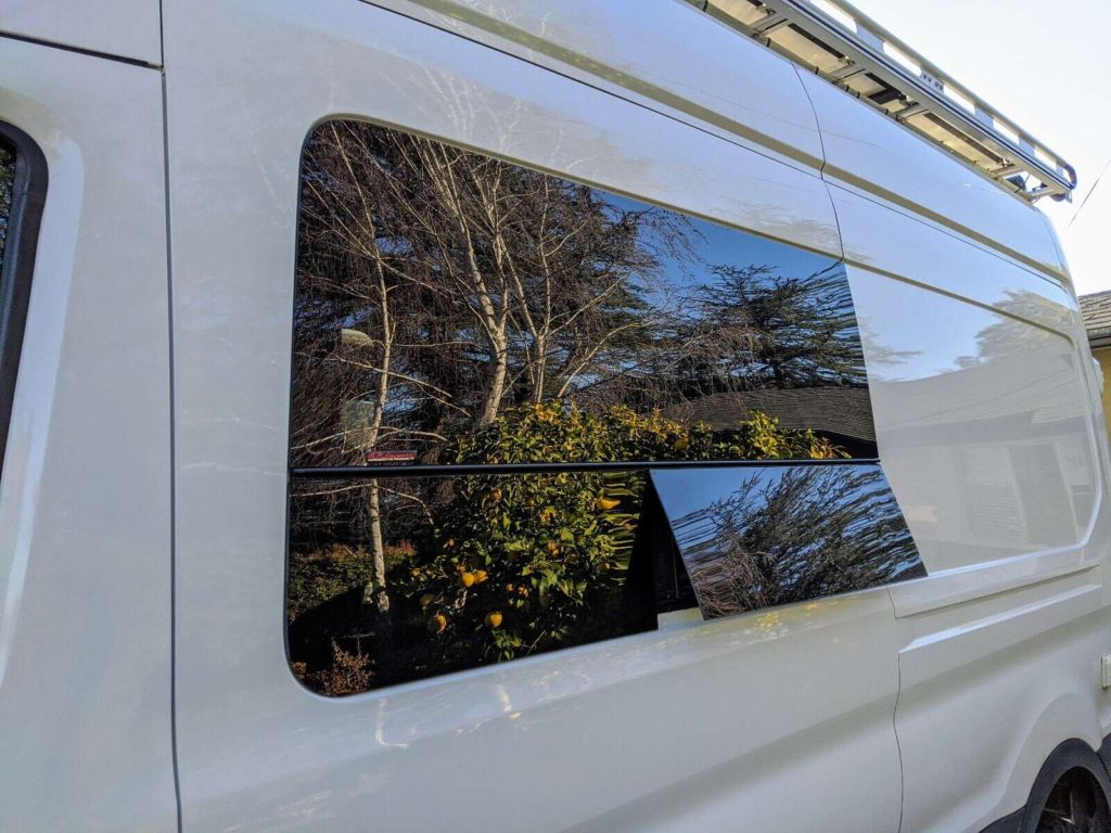 Exterior of Ford Transit van with CR Laurence camper van window installed