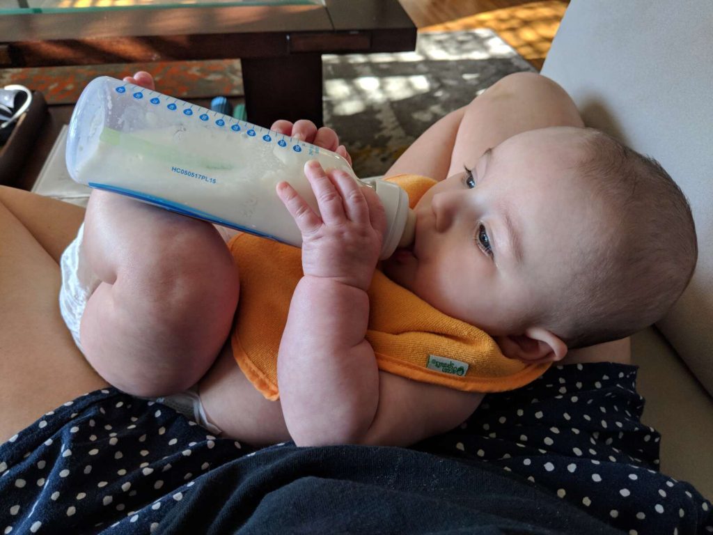 baby feeding himself bottle
