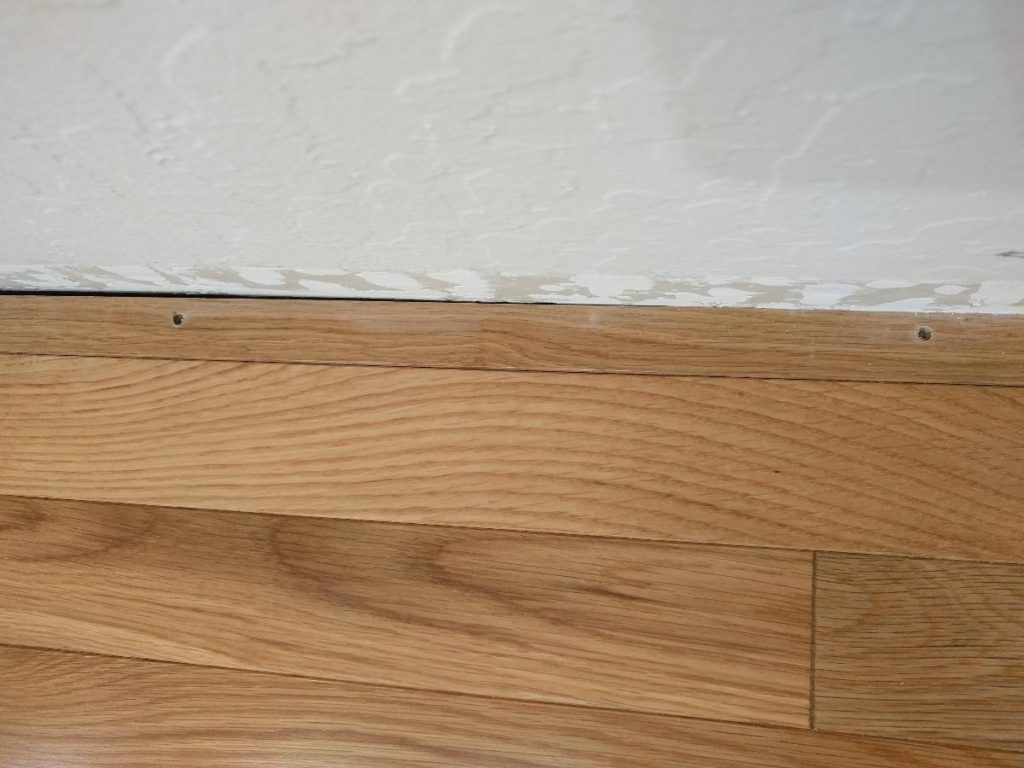 installing hardwood floor last row in room