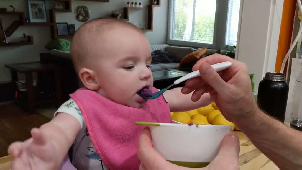baby eating sweet potatoes